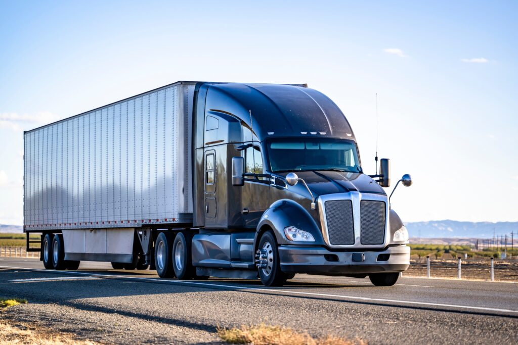 Semi truck with a trailer driving on a road