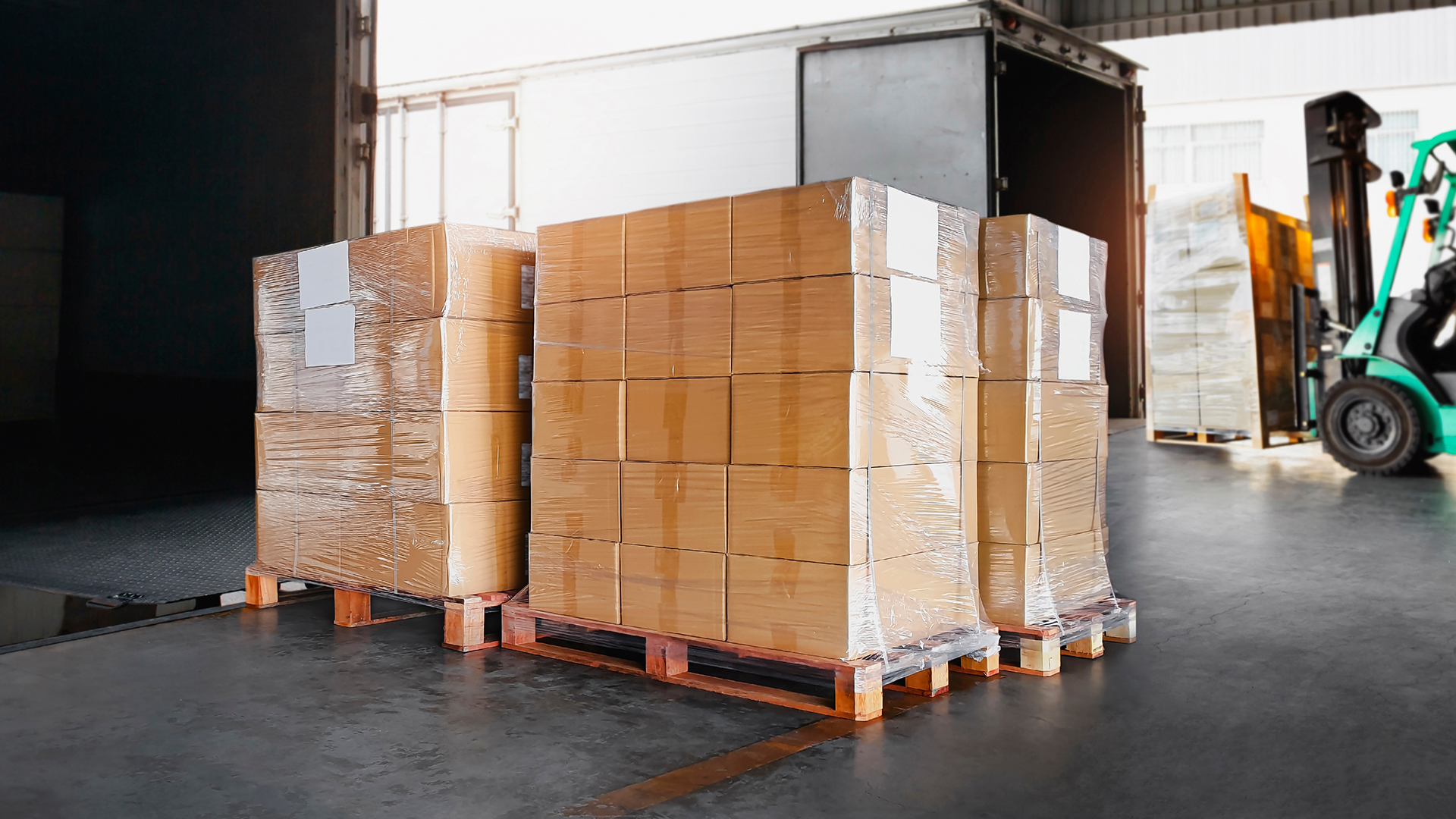 boxes stacked on pallets in a warehouse awaiting to be shipped