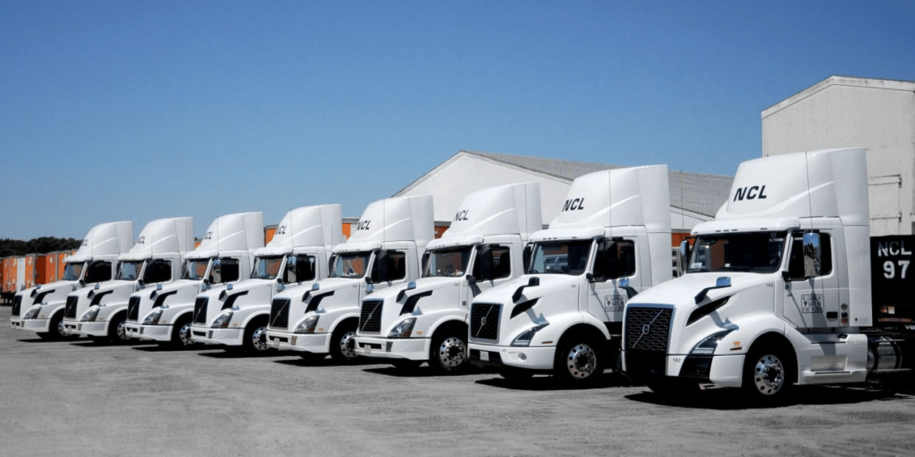 Eight NCL semi trucks lined up in a row