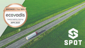 EcoVadis Bronze sustainability rating badge (Top 35%, April 2025) over an aerial view of a semi-truck traveling on a highway through green farmland, representing sustainable freight and logistics operations. Landscape orientation.