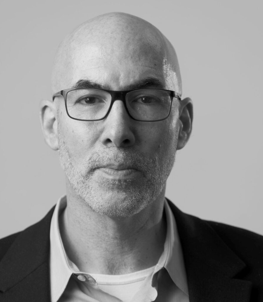 Black and white headshot of New York Times reporter Peter S. Goodman